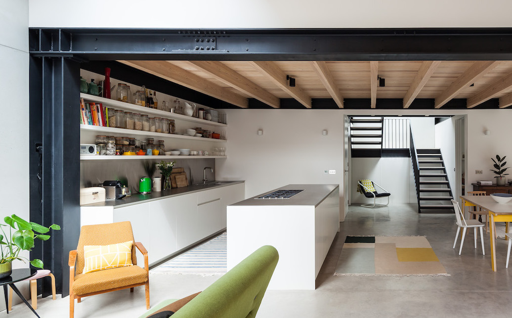 Kitchen island view into the garden through bespoke glazed windows  and doors.