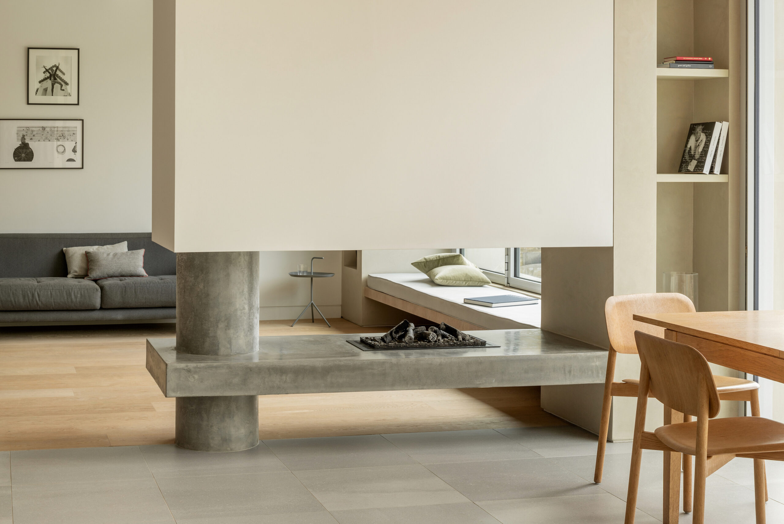 Bespoke Concrete Fireplace with dining table in foreground and lounge in background