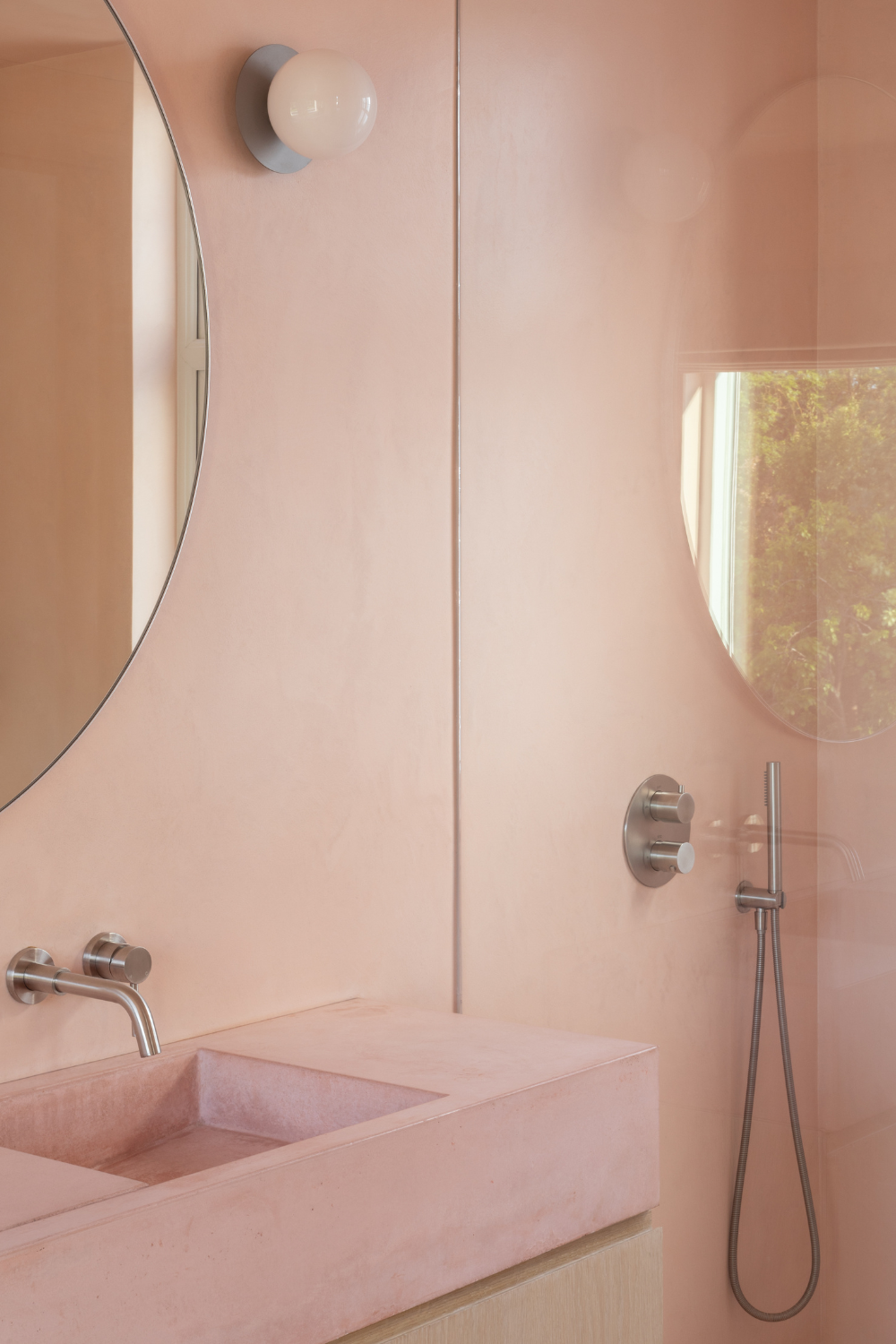 Bathroom with pink micro cement walls and pink concrete basin