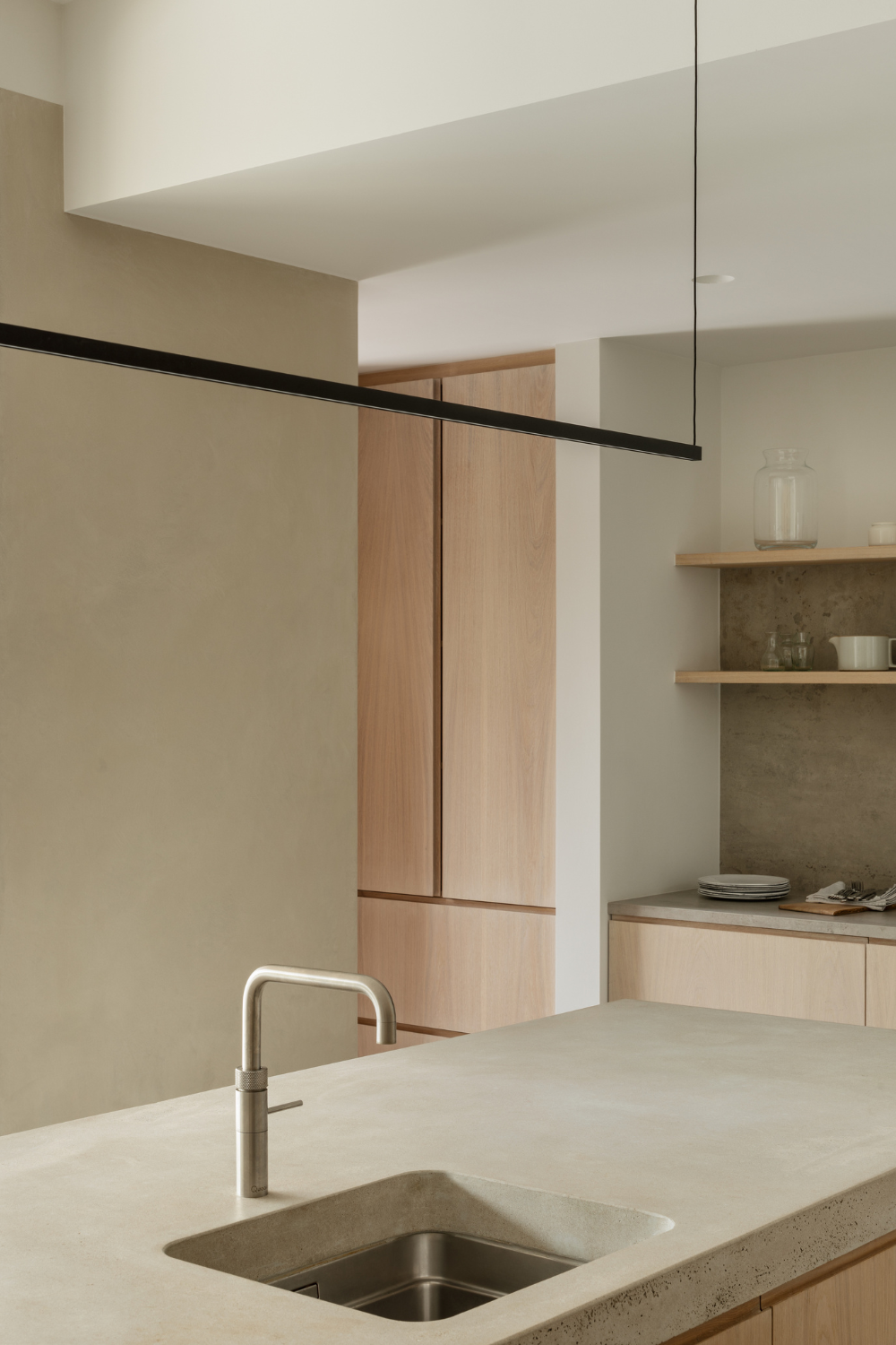 Kitchen Island with concrete work top bespoke kitchen timber units in background