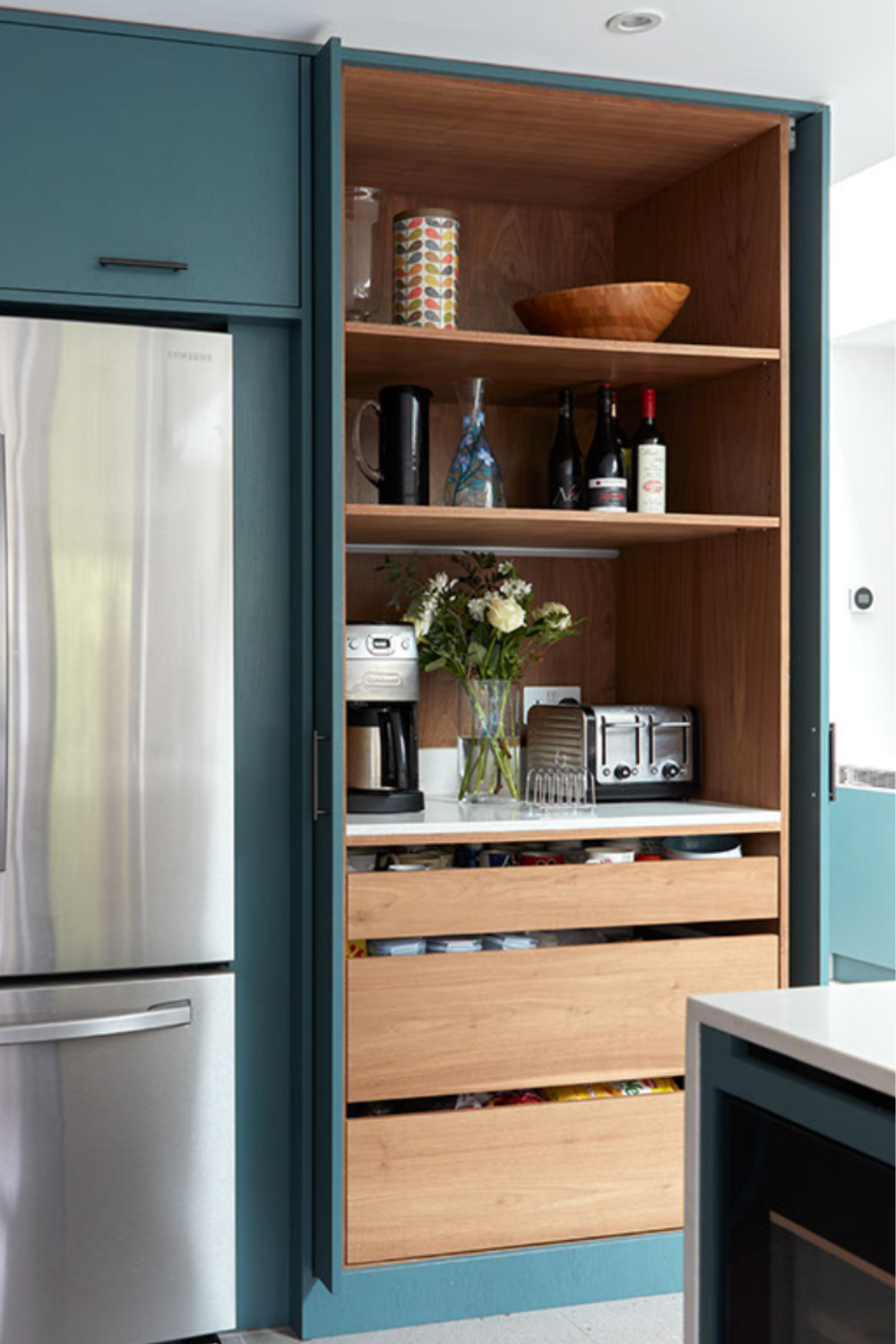 Tall Kitchen cabinet with doors that are hidden when open. 