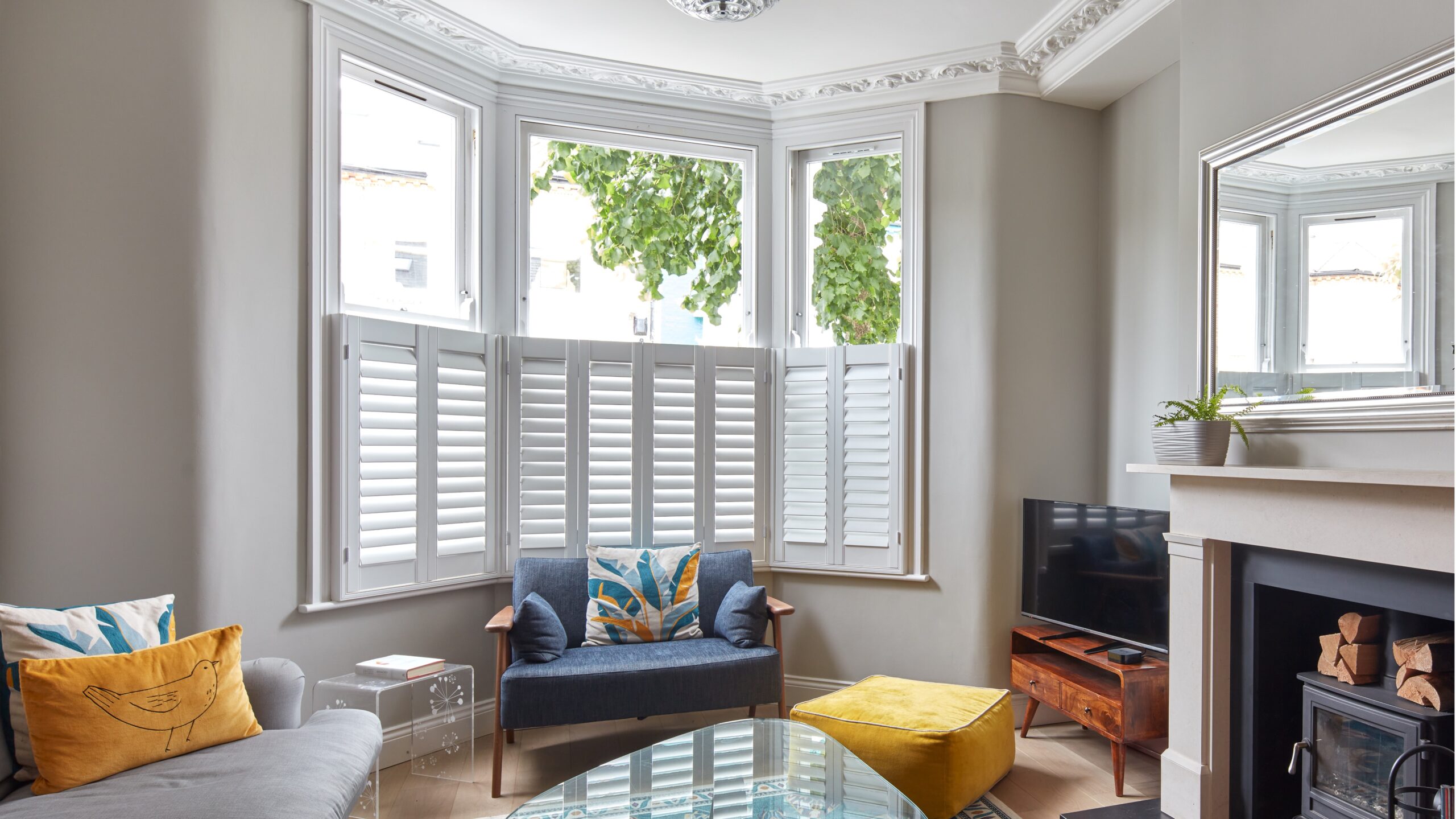 Lounge sitting room with half shuttered windows with fireplace